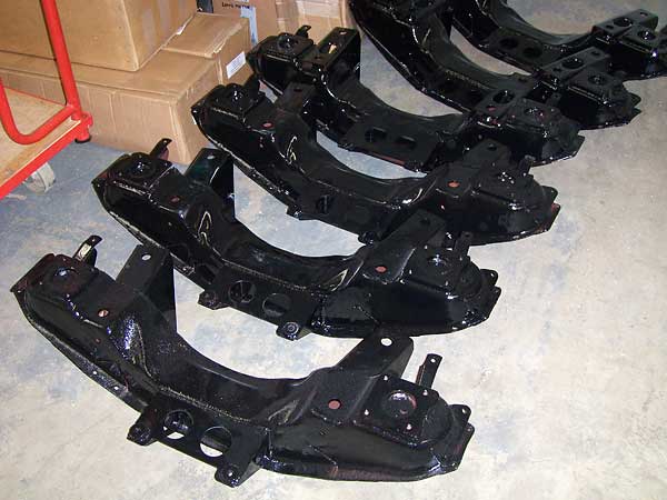 MGB front crossmembers with modifications for power steering.