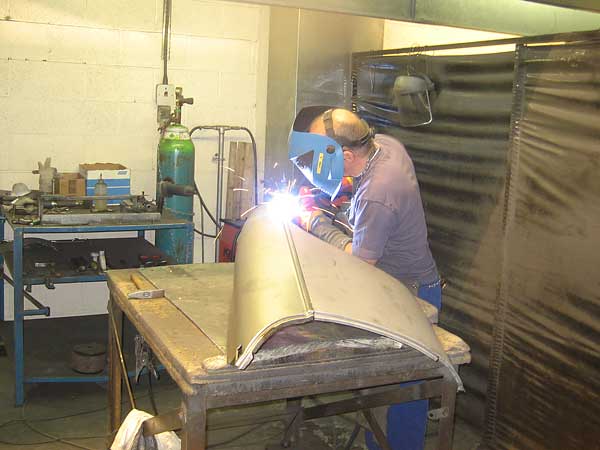Welding a front wing assembly. (The front wings are assembled from ten parts.)