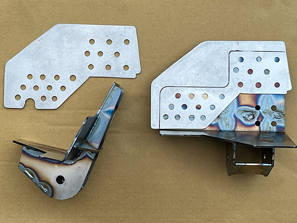 The lower link brackets are 5-piece assemblies (below the floor).