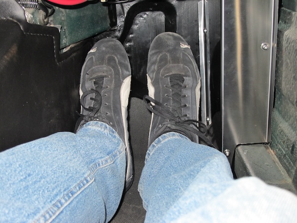 Installed in passenger-side footwell, behind a simple stainless steel cover.