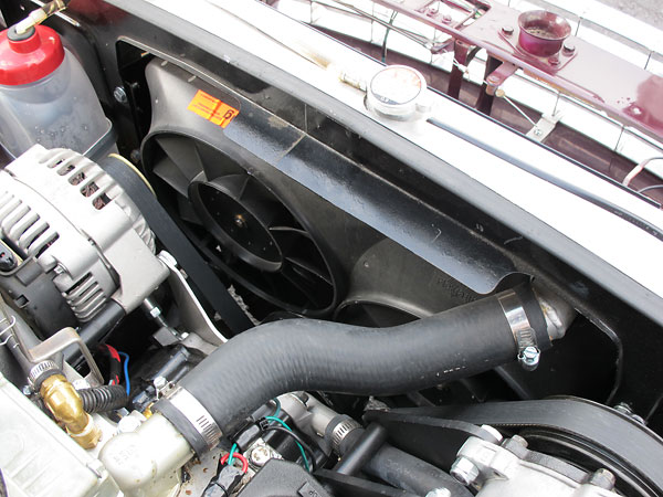 Dual electric fans mounted on plastic fan shroud.