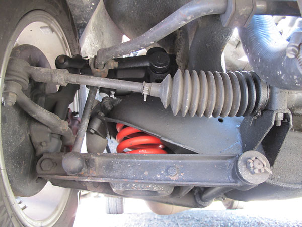 Stock MGB front suspension, except for lowering springs and heavier duty bushings.