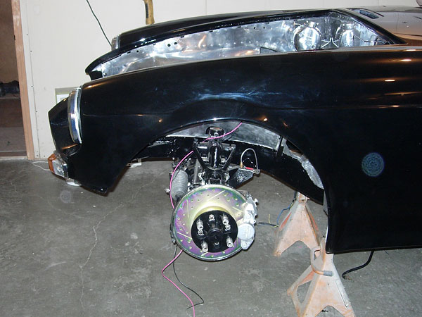 Stock MGB calipers with EBC slotted and dimpled rotors.