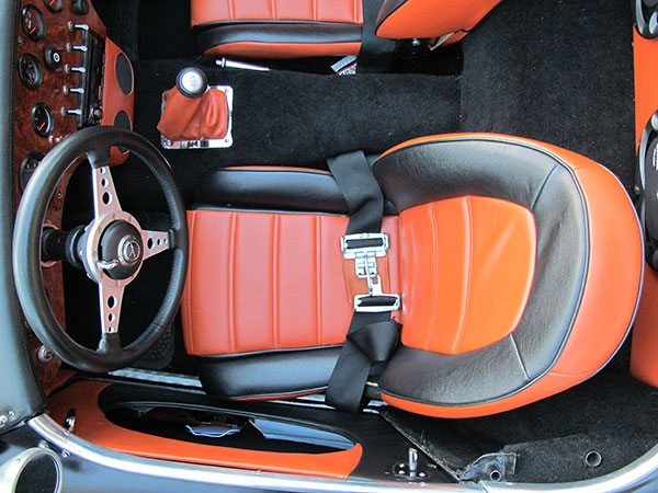 Mazda Miata seats with headrests removed for lower profile to match rear cowl.