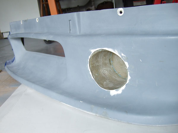 Modified air dam, with new pockets molded-in for installation of recessed driving lights.